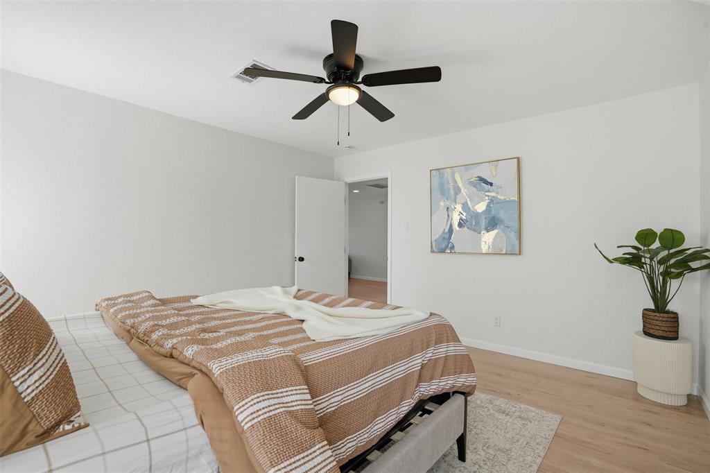 2012 Tennessee Avenue Dallas, TX 75224 - Photo 14 of 28 a bedroom with a bed and painting on the wall