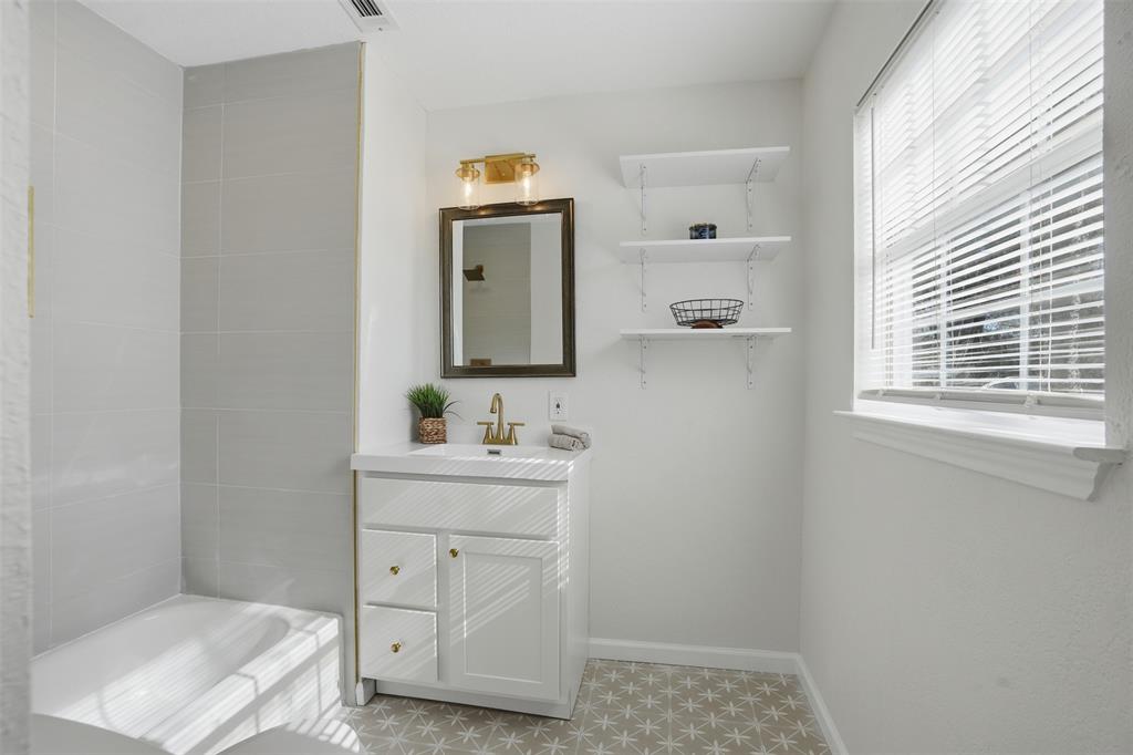 2012 Tennessee Avenue Dallas, TX 75224 - Photo 18 of 28 a bathroom with a toilet a sink a vanity and mirror