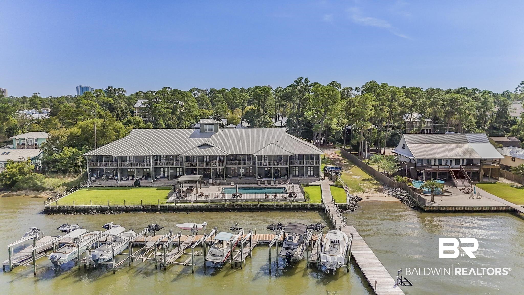 25773 Canal Road Orange Beach, AL 36561 - Photo 19 of 32 Dock area featuring boat lift, a water view, and an outdoor pool