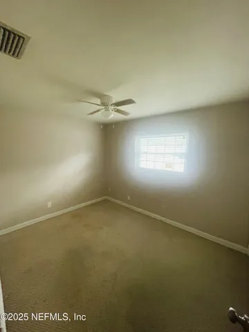 an empty room with closet area