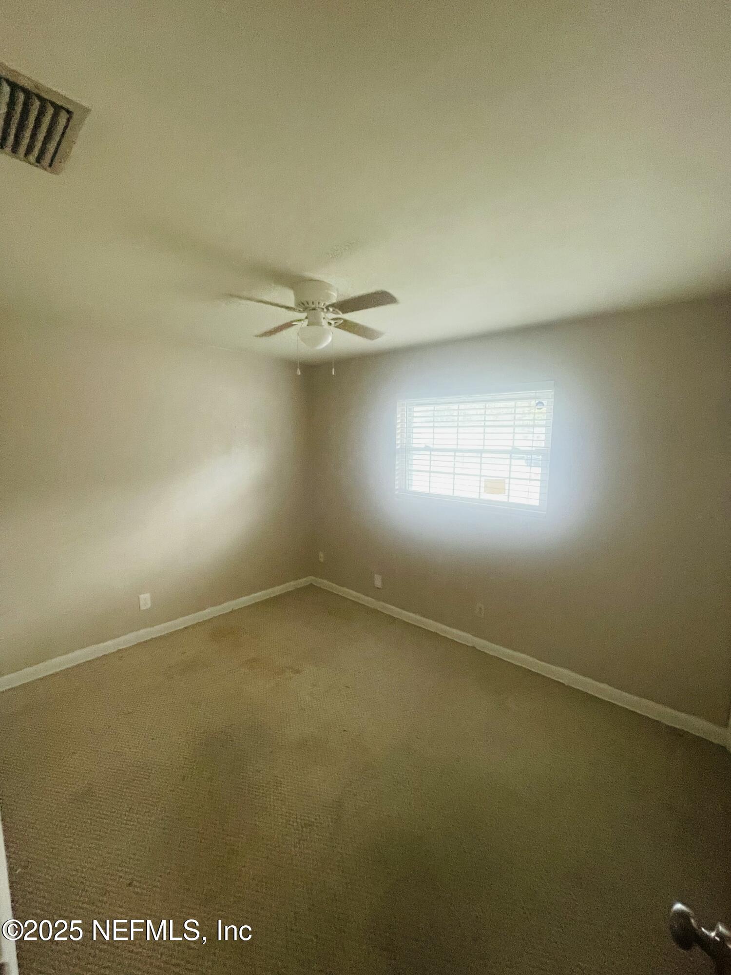 6643 Heidi Road Jacksonville, FL 32277 - Photo 14 of 45 an empty room with a empty space and windows
