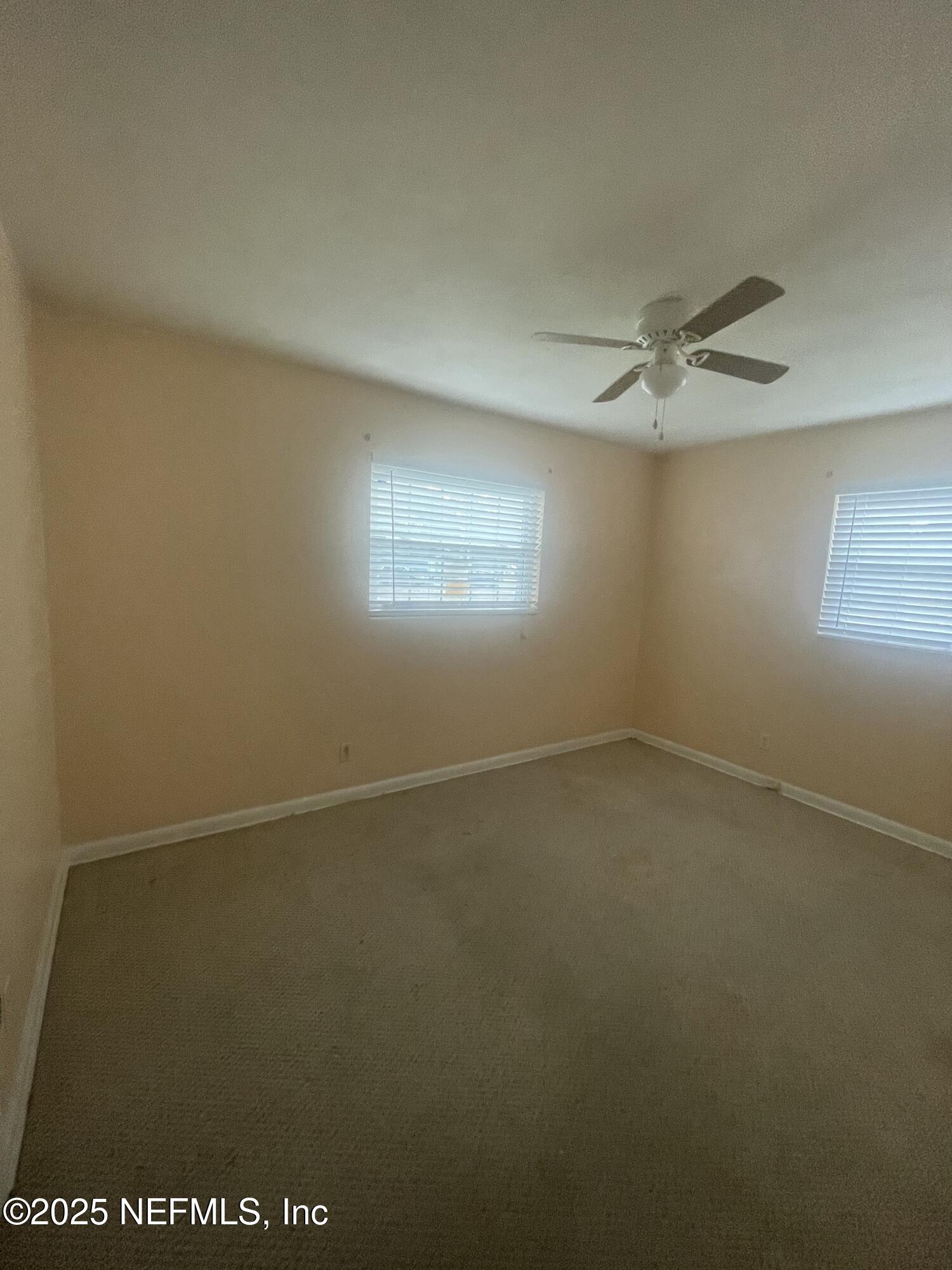 6643 Heidi Road Jacksonville, FL 32277 - Photo 19 of 45 an empty room with a window and a fan