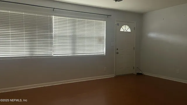 a view of an empty room with a window