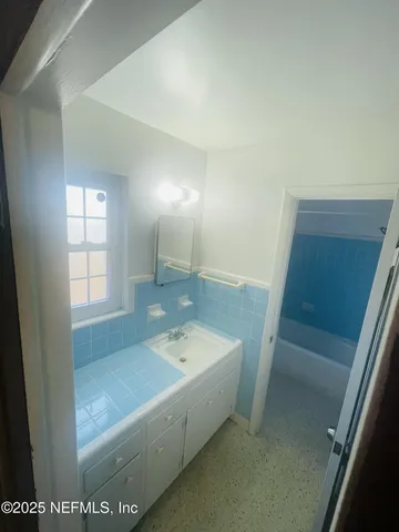 an empty room with a empty space and a ceiling fan