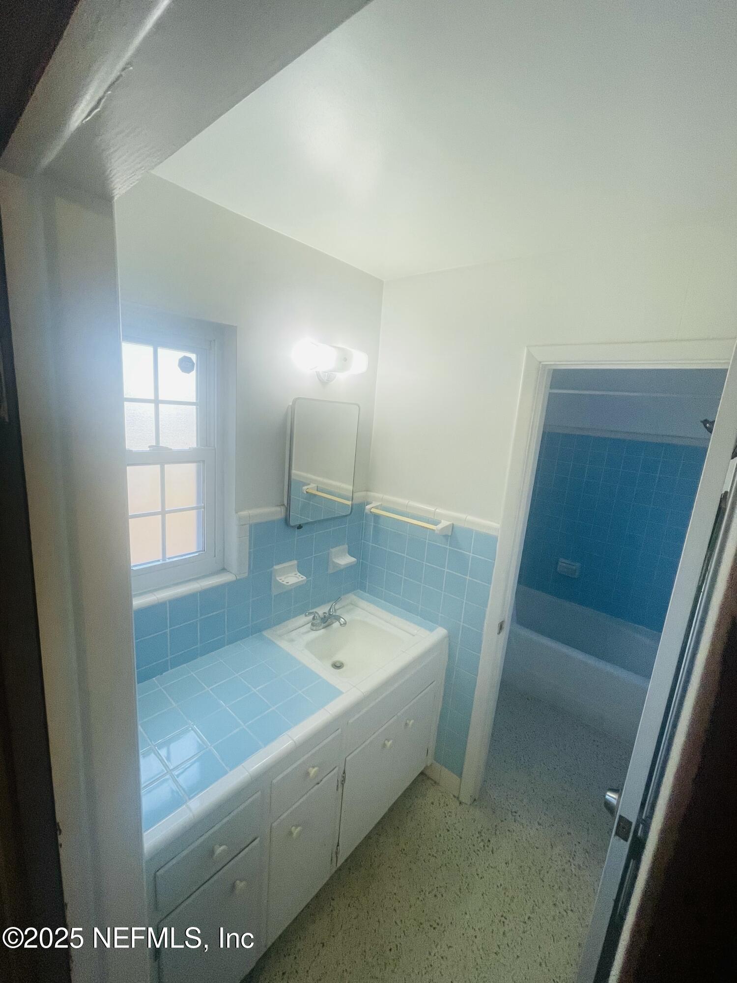 6643 Heidi Road Jacksonville, FL 32277 - Photo 26 of 45 a bathroom with a tub sink and mirror
