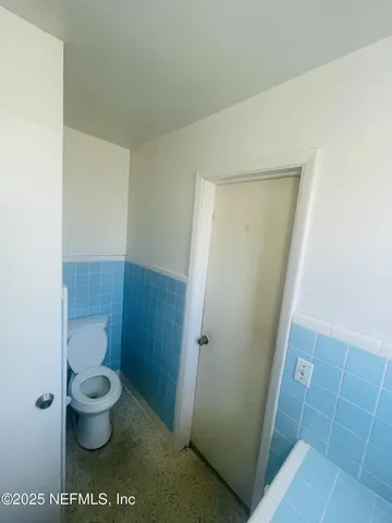 an empty room with a empty space and windows