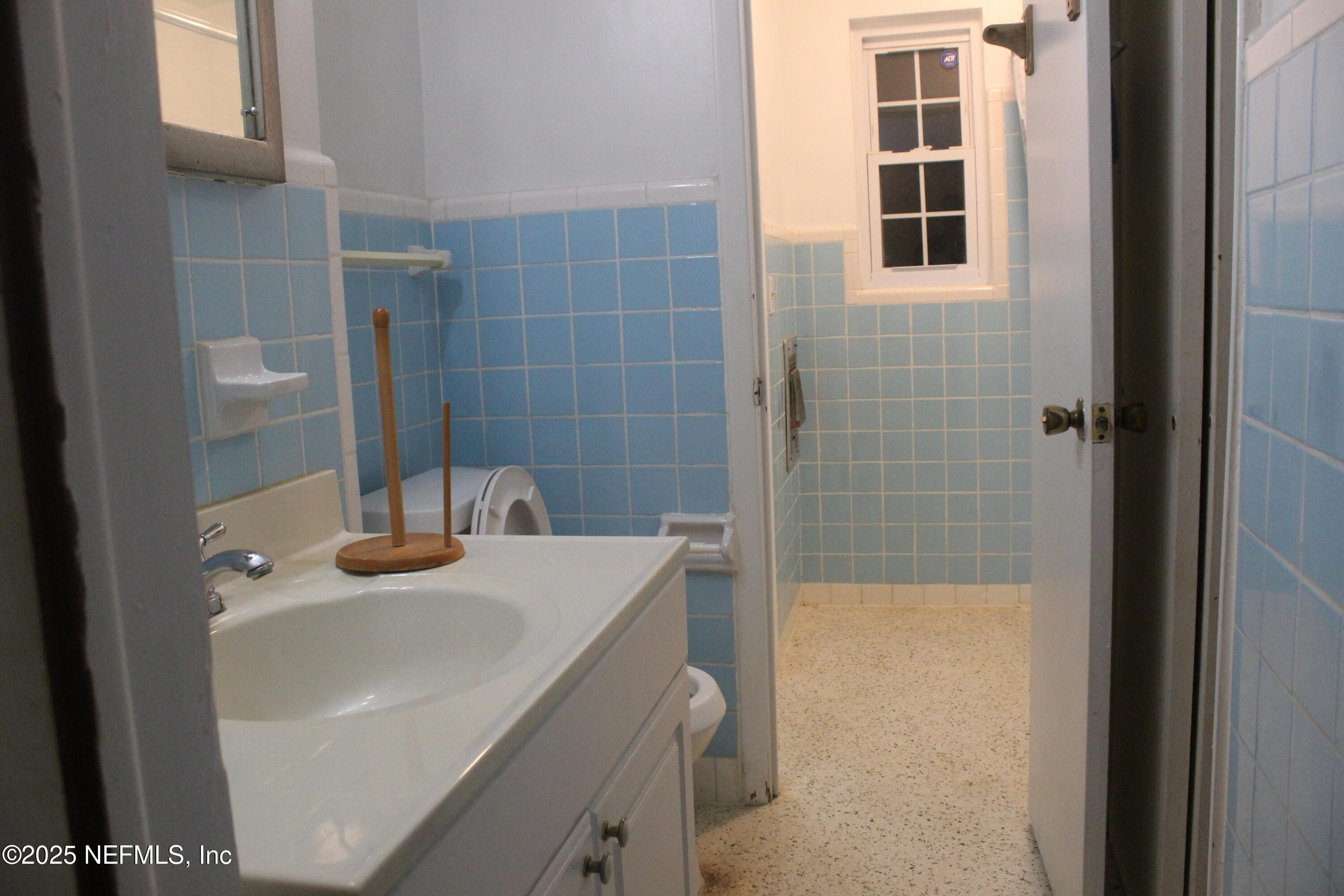 6643 Heidi Road Jacksonville, FL 32277 - Photo 30 of 45 a bathroom with a sink and a mirror