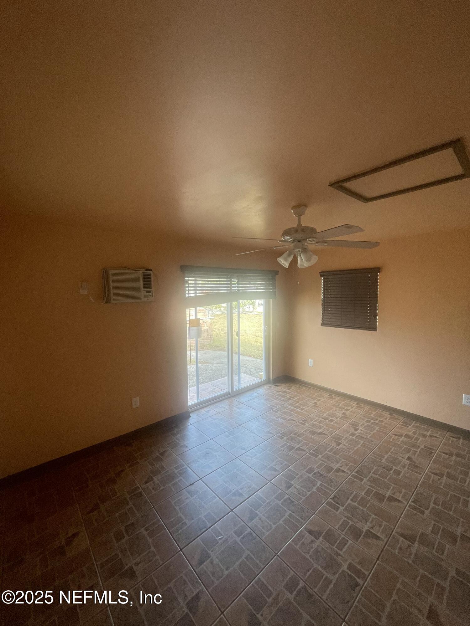 6643 Heidi Road Jacksonville, FL 32277 - Photo 38 of 45 an empty room with a empty space and windows