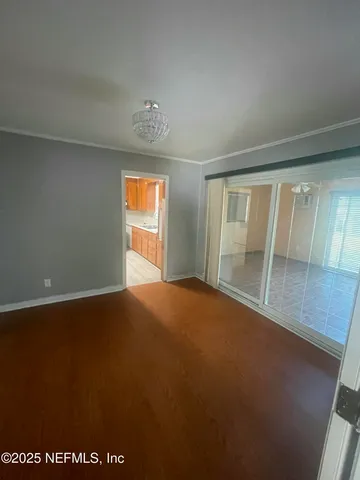 a view of a refrigerator in kitchen and a window