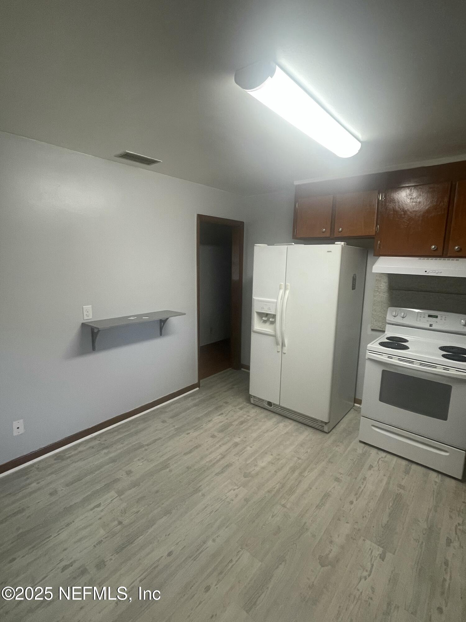 6643 Heidi Road Jacksonville, FL 32277 - Photo 10 of 45 a view of a refrigerator in kitchen and a window