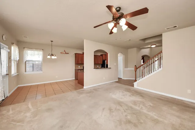en view interior of a house with a chandelier fan and windows