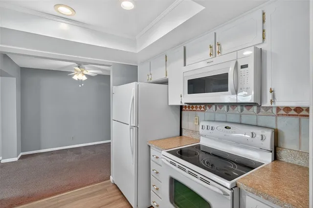 a kitchen with a refrigerator and a stove top oven