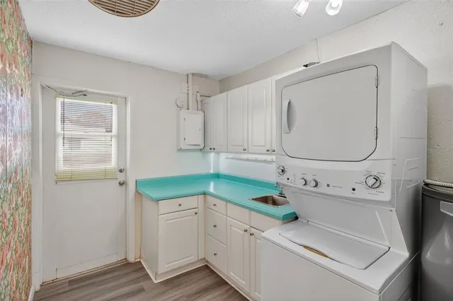 a utility room with cabinets washer and dryer