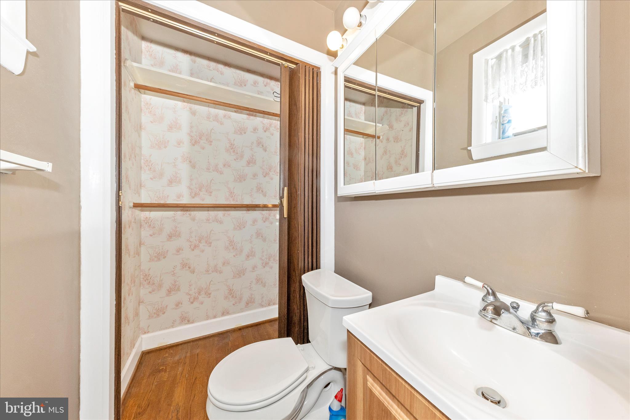 11802 Pittson Road Silver Spring, MD 20906 - Photo 23 of 50 a bathroom with a sink mirror vanity and toilet