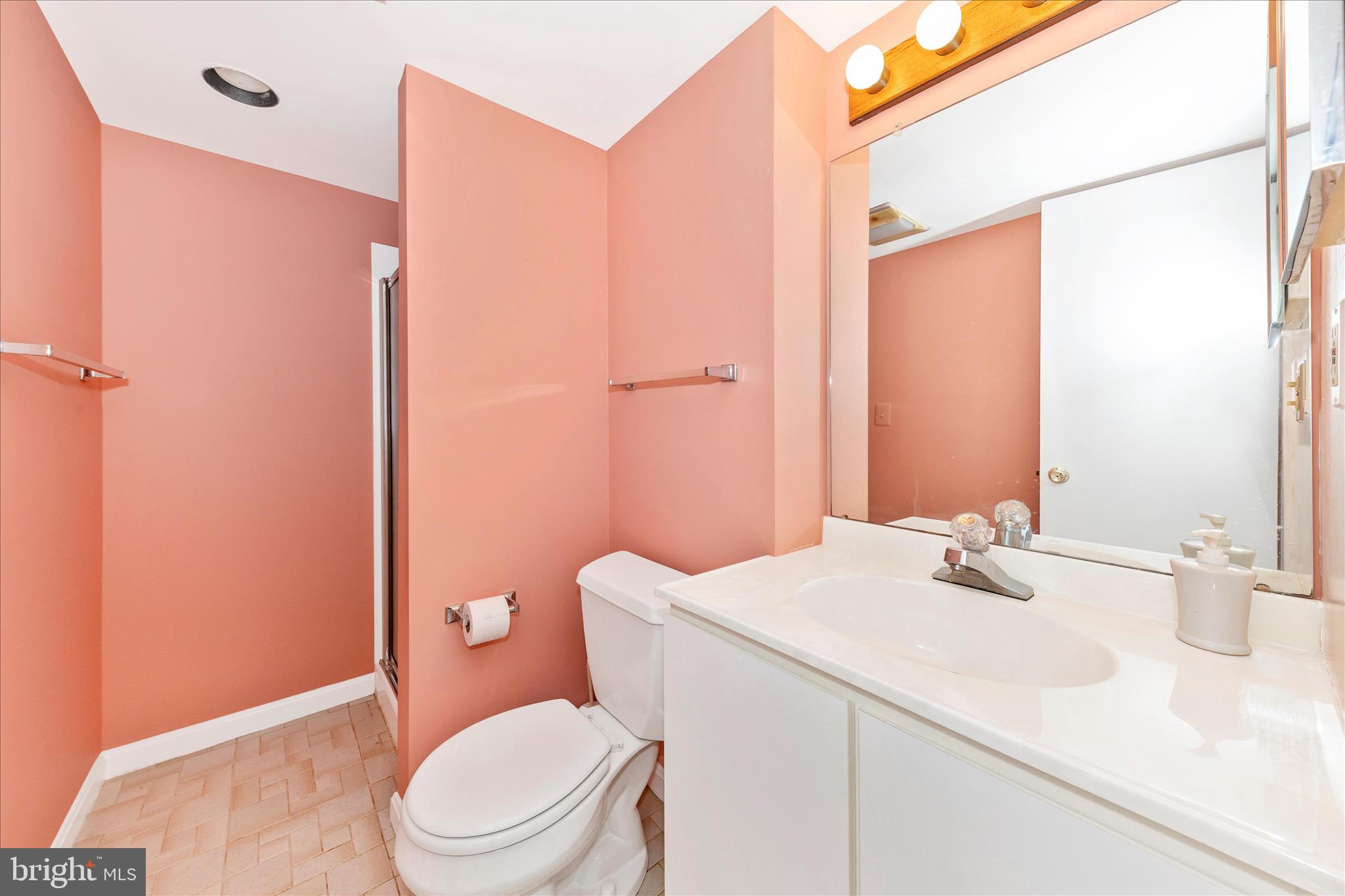 11802 Pittson Road Silver Spring, MD 20906 - Photo 39 of 50 a bathroom with a sink a toilet and shower curtain