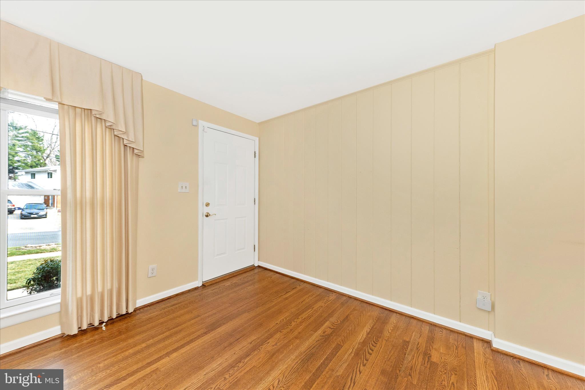 11802 Pittson Road Silver Spring, MD 20906 - Photo 4 of 50 a view of an empty room with wooden floor and a window