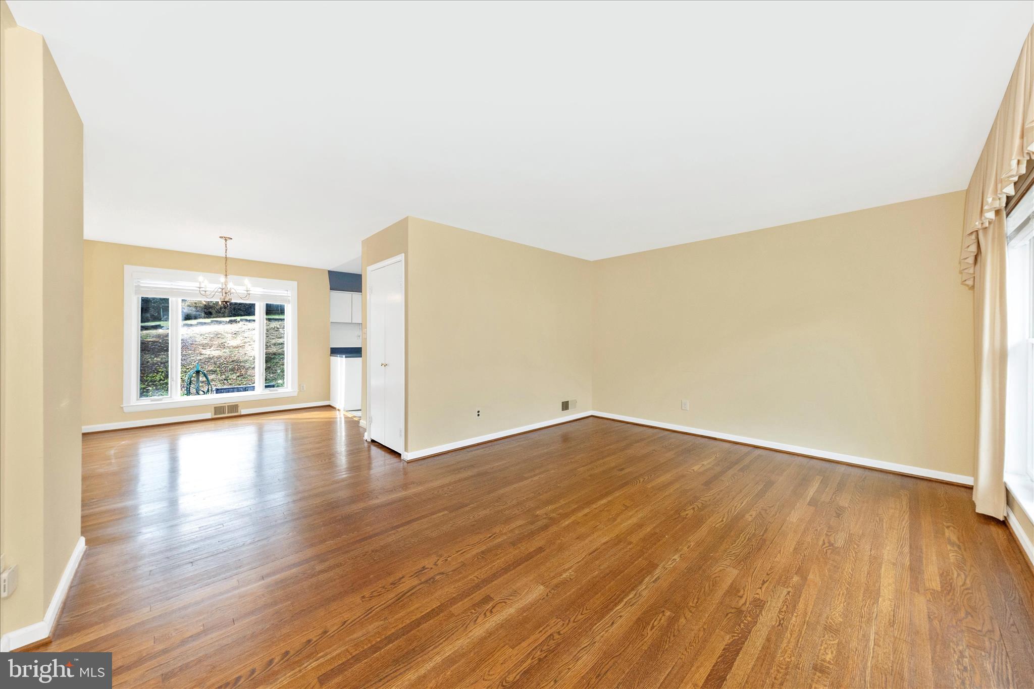 11802 Pittson Road Silver Spring, MD 20906 - Photo 6 of 50 an empty room with wooden floor and windows