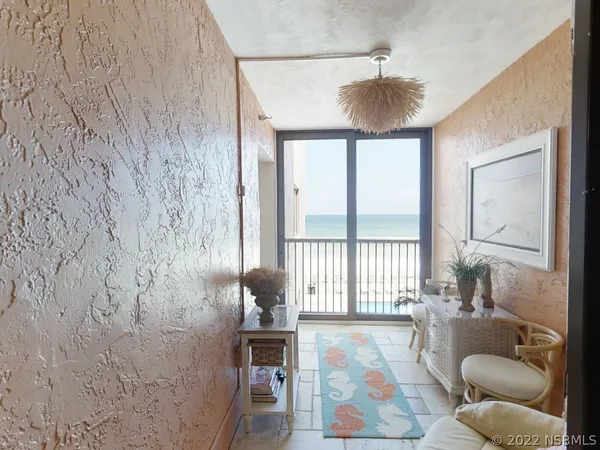 a living room with furniture and a floor to ceiling window
