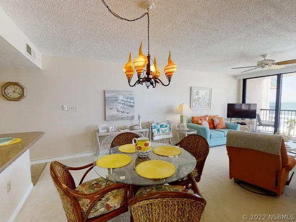 a living room with furniture a window and a chandelier