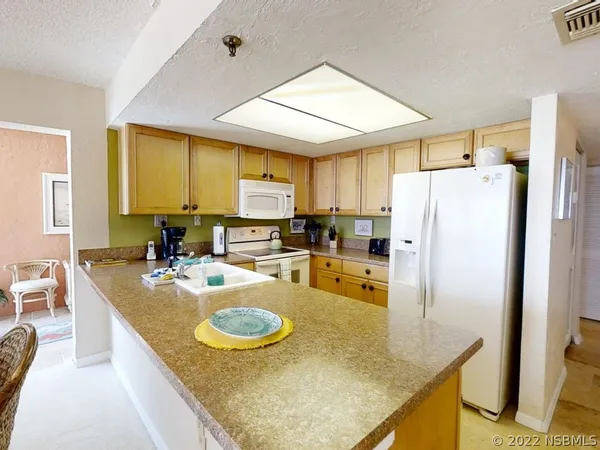 a kitchen with refrigerator and stove