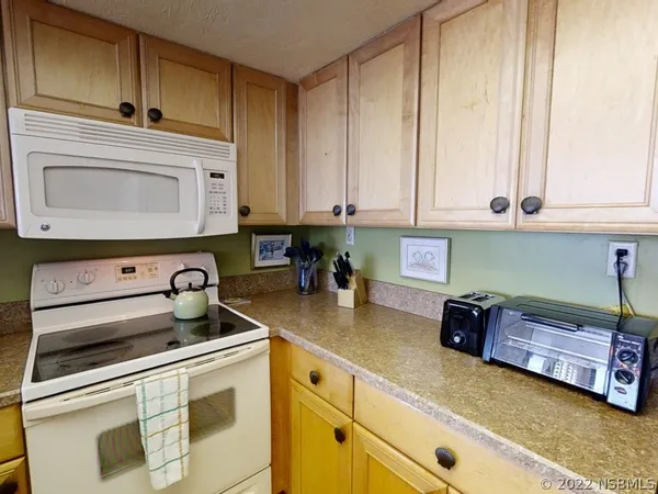 a kitchen with stainless steel appliances granite countertop a sink a stove and cabinets