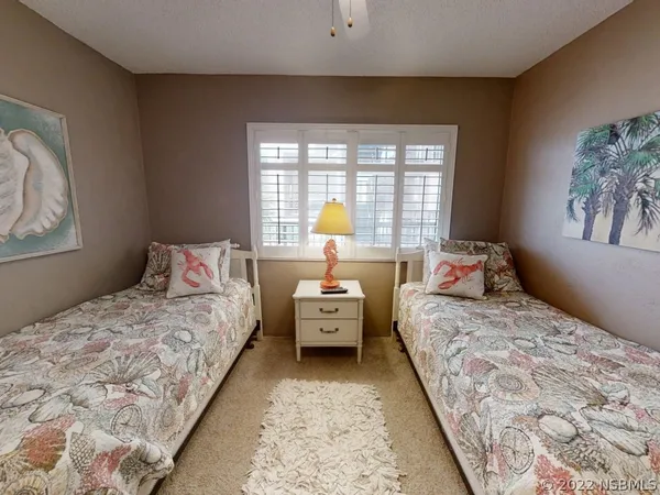 a bedroom with bed and window