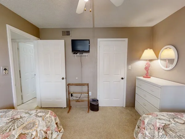 a bedroom with a bed and a television