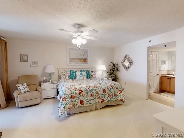 a bedroom with bed and a chandelier