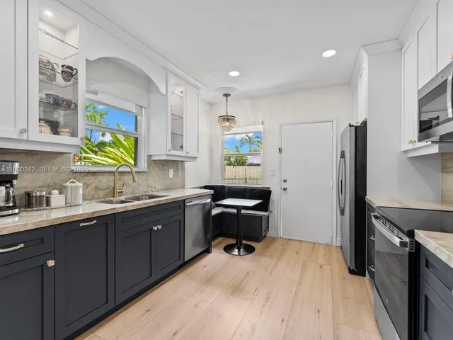 a kitchen with a sink appliances and cabinets