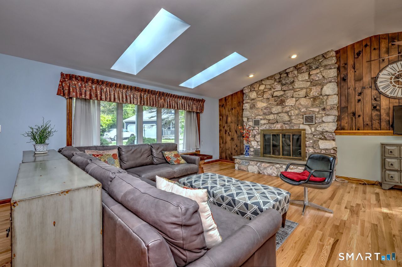 90 Brook Hill Road Hamden, CT 06514 - Photo 10 of 38 Living room with fire place, hardwood floor and skylight