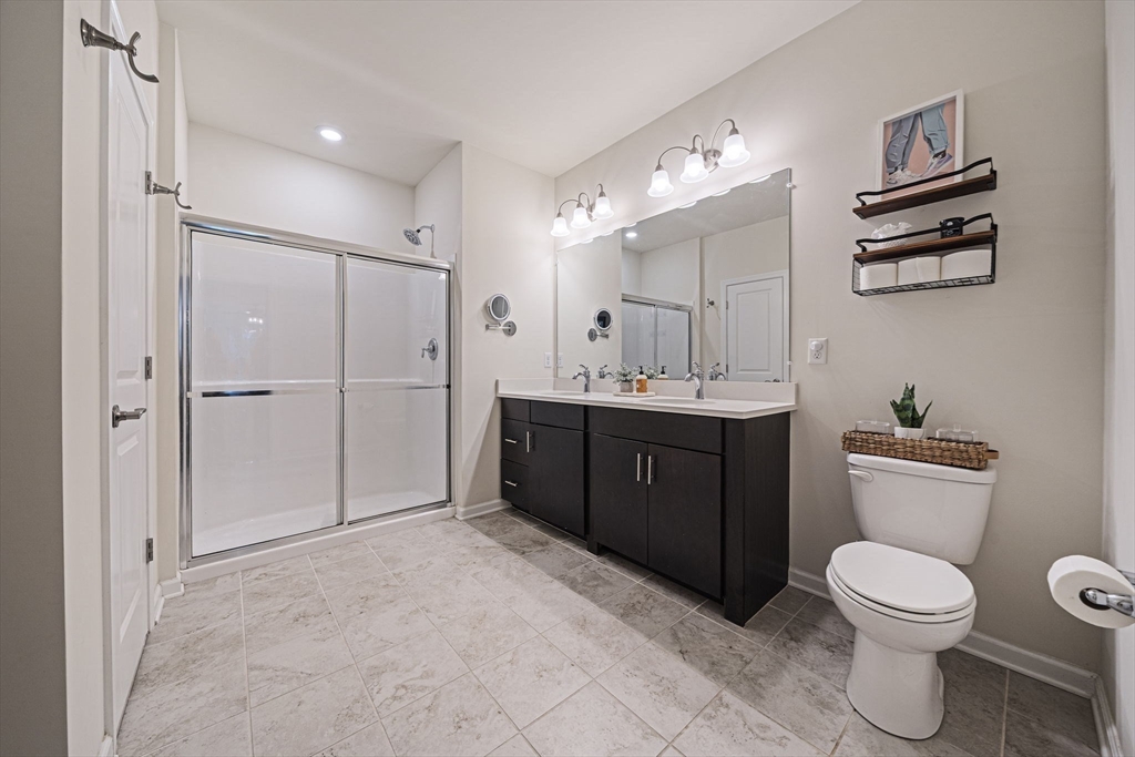 70 Trotter Road, Unit 310 Weymouth, MA 02190 - Photo 10 of 14 a spacious bathroom with a toilet sink shower and mirror
