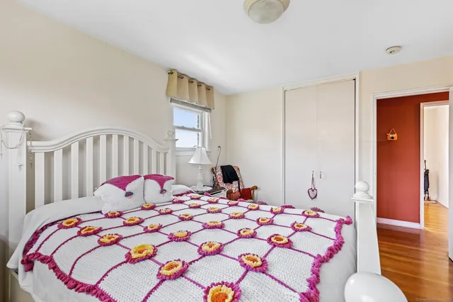 a bedroom with a bed and a lamp