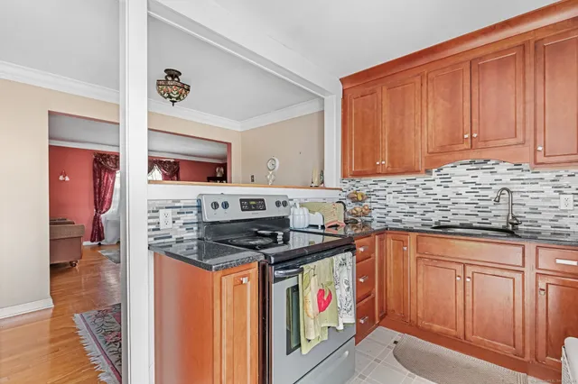 a kitchen with stainless steel appliances granite countertop a stove and cabinets