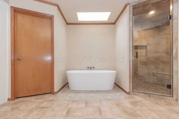 a bathroom with a bathtub and shower