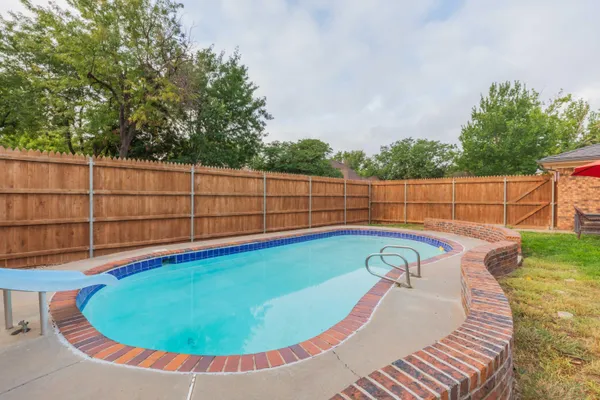 a view of a swimming pool with a outdoor seating