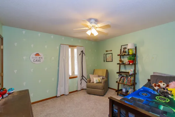 a bedroom with furniture and a window