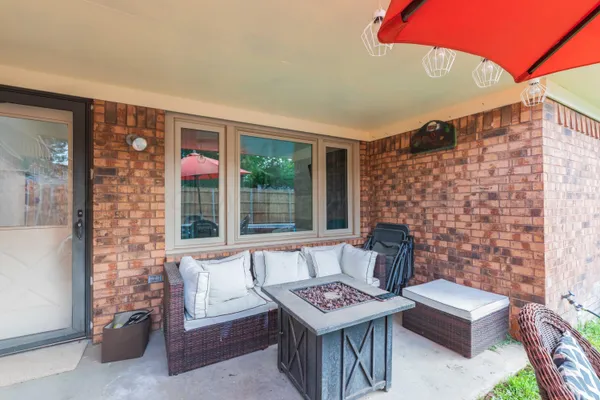 a view of a patio with couches table and chairs and potted plants
