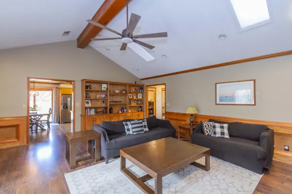 a living room with furniture and wooden floor