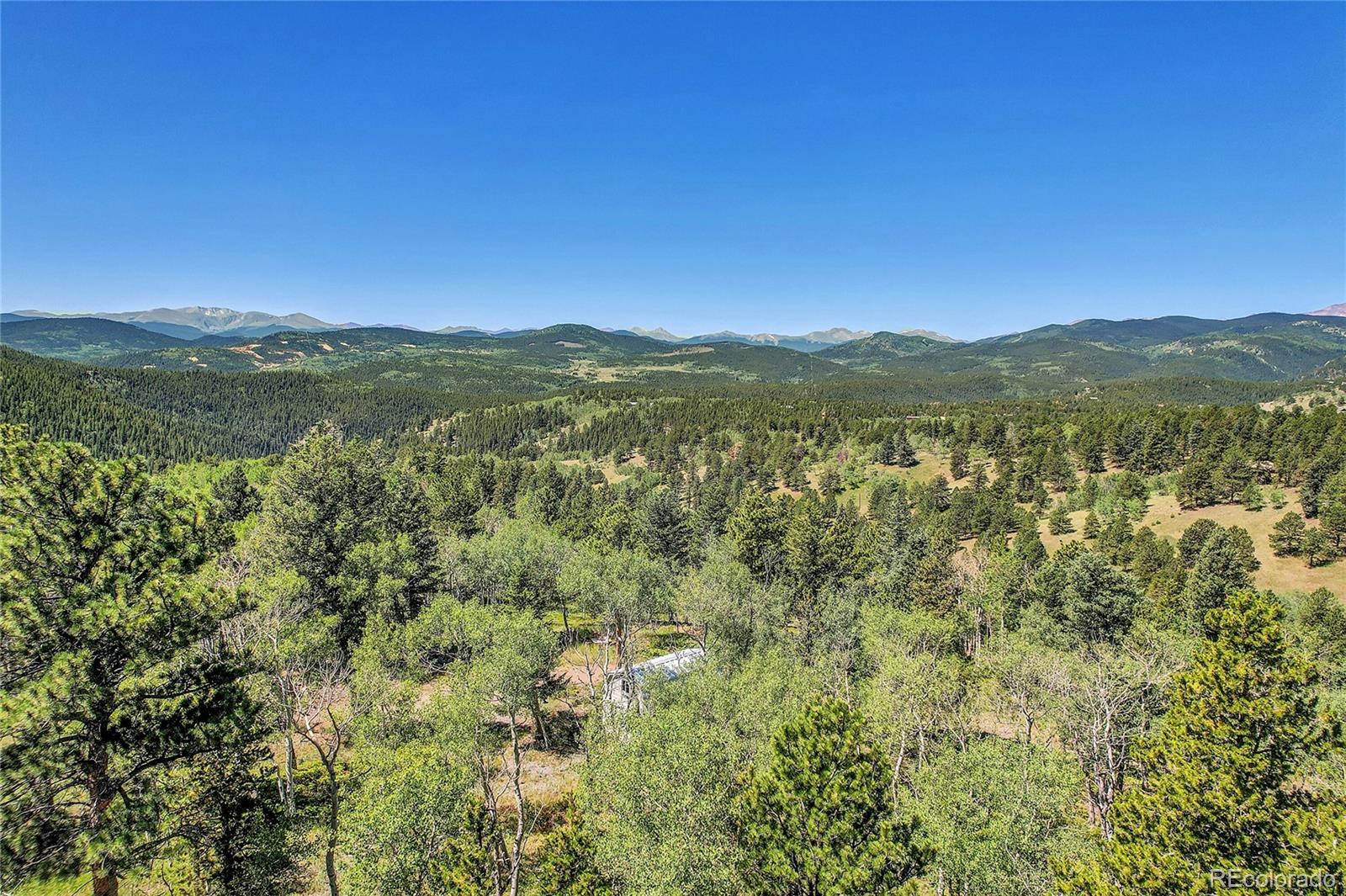 4 Hughesville Road Black Hawk, CO 80422 - Photo 28 of 29 a view of a mountain range with lush green forest