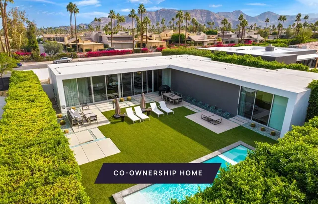 a view of a swimming pool with a bench and lawn chairs