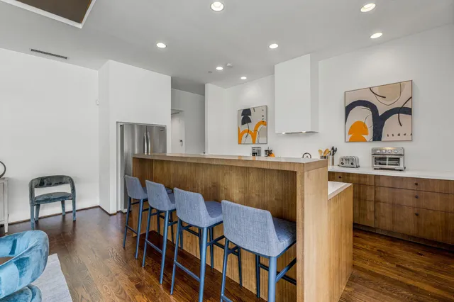 a kitchen with stainless steel appliances granite countertop a stove a sink a refrigerator and cabinets