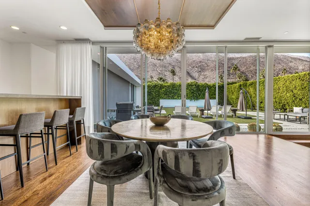 a dining table with chairs and wooden floor