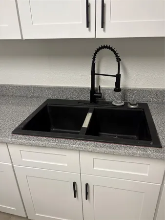 a close view of a sink a stove and kitchen island with a stove