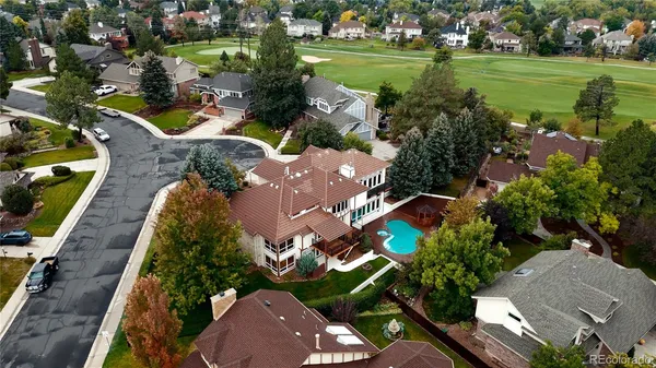 an aerial view of a house with a garden and lake view