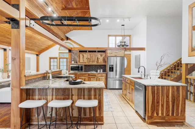 a kitchen with granite countertop lots of counter top space and windows