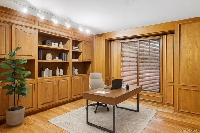 a view of a workspace with furniture and a potted plant