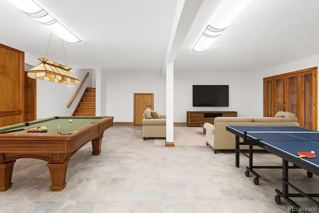a room with furniture pool table and flat screen tv
