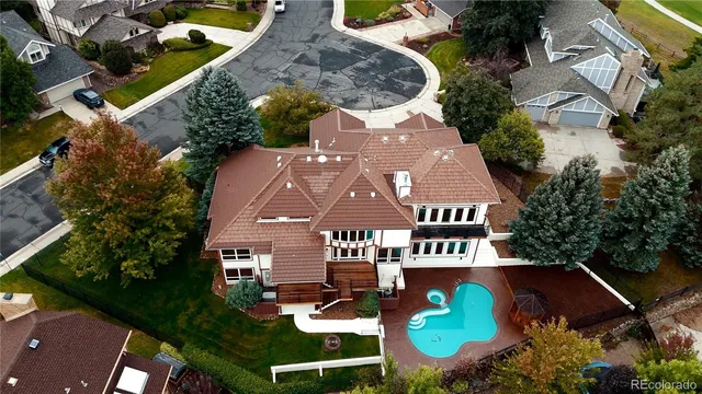 an aerial view of a house with garden space and street view