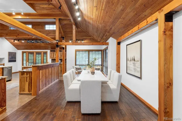 a dining room with furniture window and wooden floor