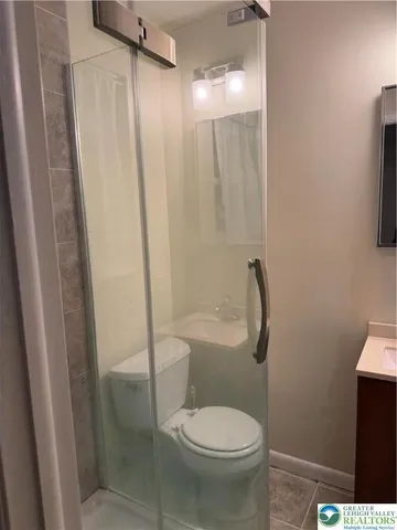 a bathroom with a toilet and a shower